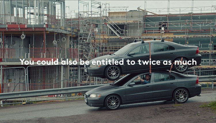 The images shows a man driving a car with an extra car on the roof. The caption on the image reads You could also be entitled to twice as much.